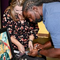 Former Tiger and NFL player signs his NFL Raiders cards.